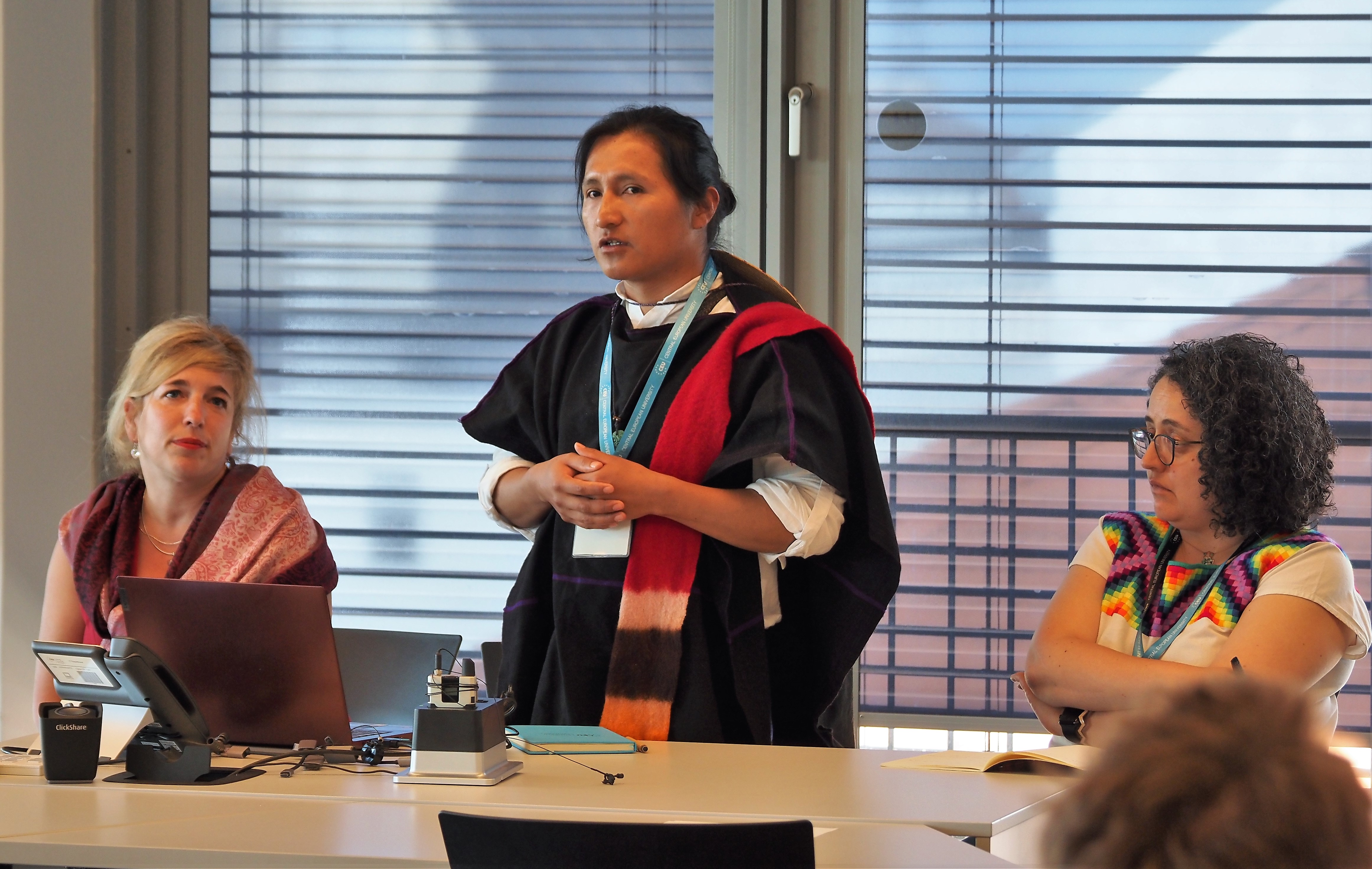 One faculty memeber speaking standing up behind a table